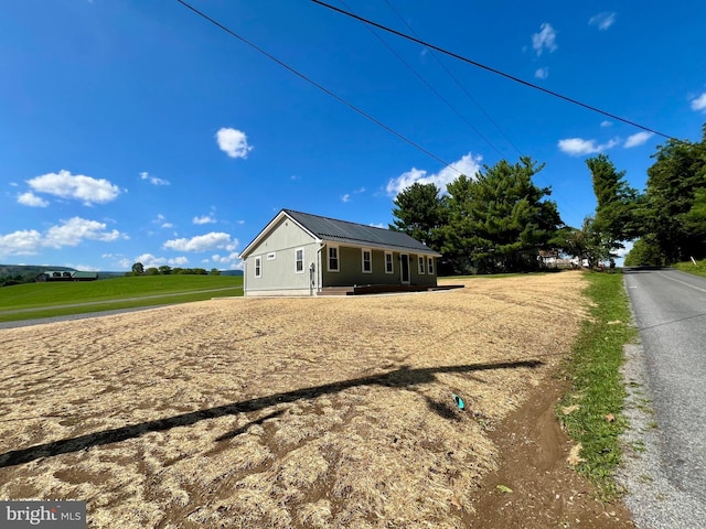 view of front facade featuring a rural view