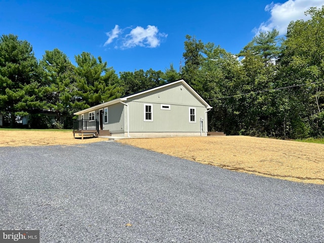 view of home's exterior featuring a yard and a wooden deck