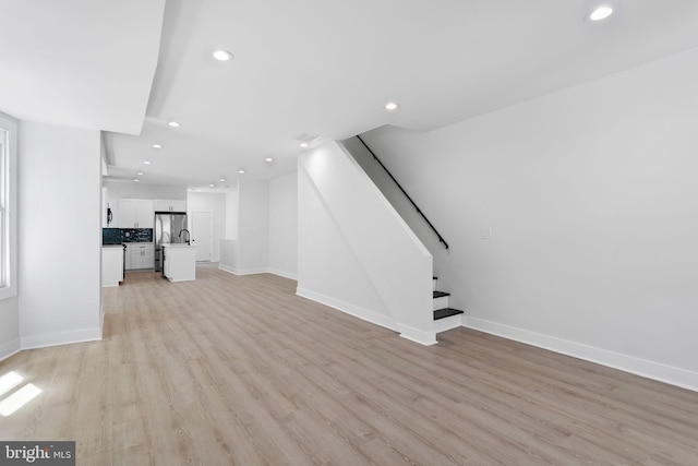 unfurnished living room with light wood-type flooring