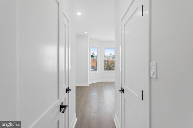 corridor with light hardwood / wood-style floors