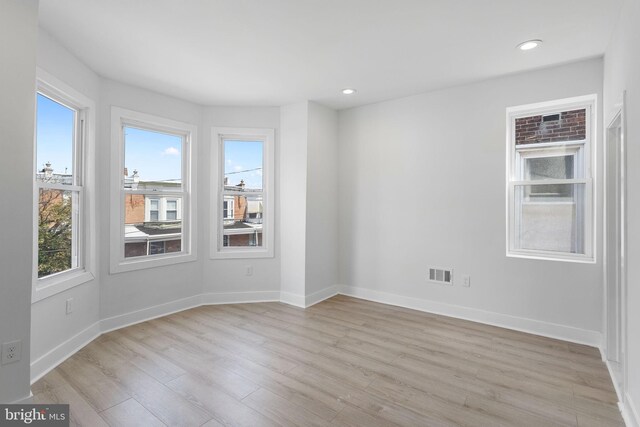 spare room featuring light hardwood / wood-style floors