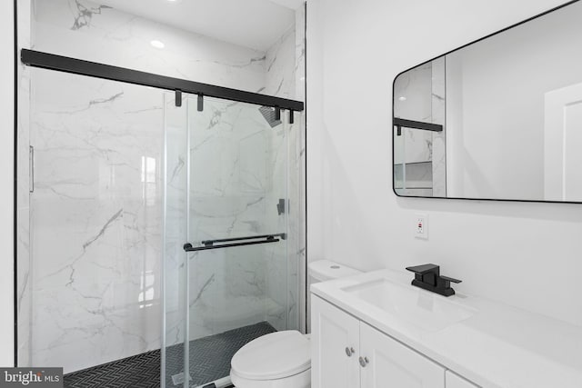 bathroom with vanity, toilet, and an enclosed shower