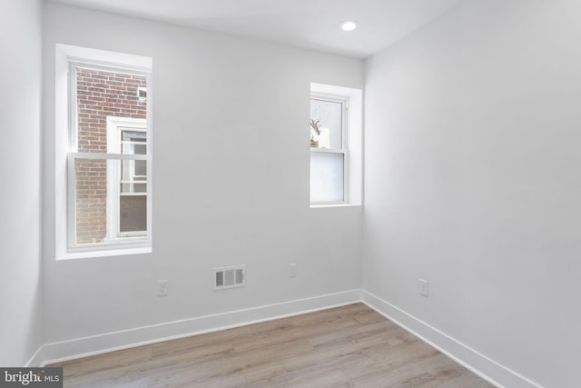 unfurnished room featuring light hardwood / wood-style floors