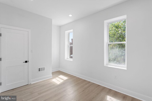 spare room featuring light wood-type flooring