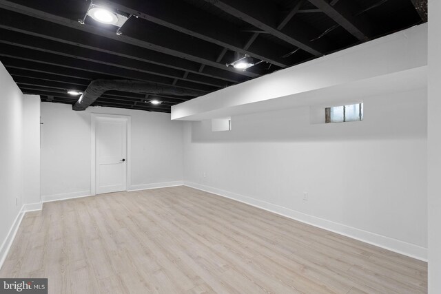 basement featuring light wood-type flooring