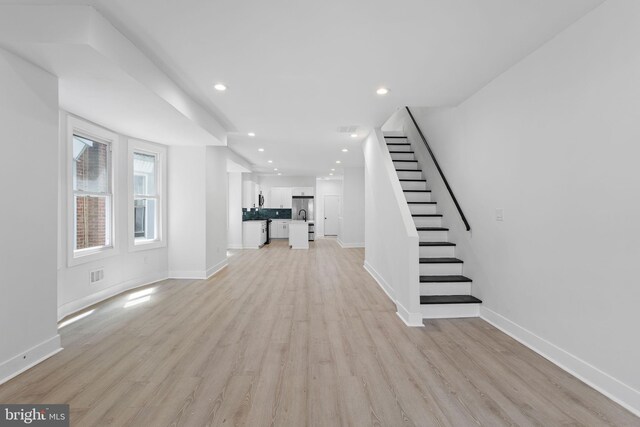 unfurnished living room with light wood-type flooring