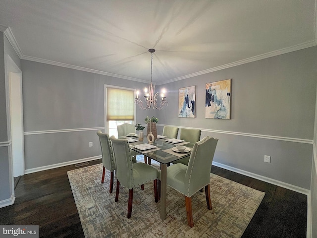 dining area featuring a chandelier, baseboards, and wood finished floors