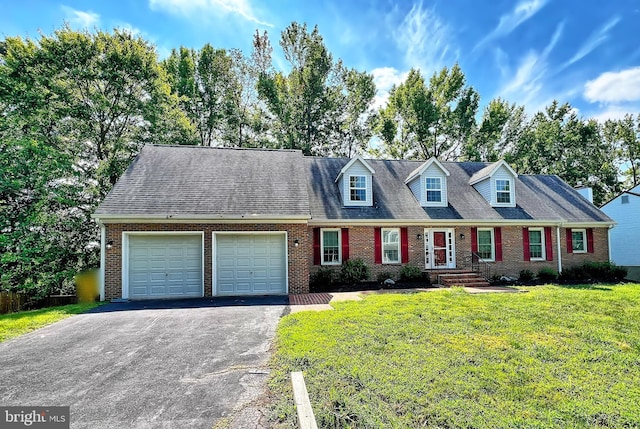 new england style home with brick siding, aphalt driveway, a garage, and a front yard