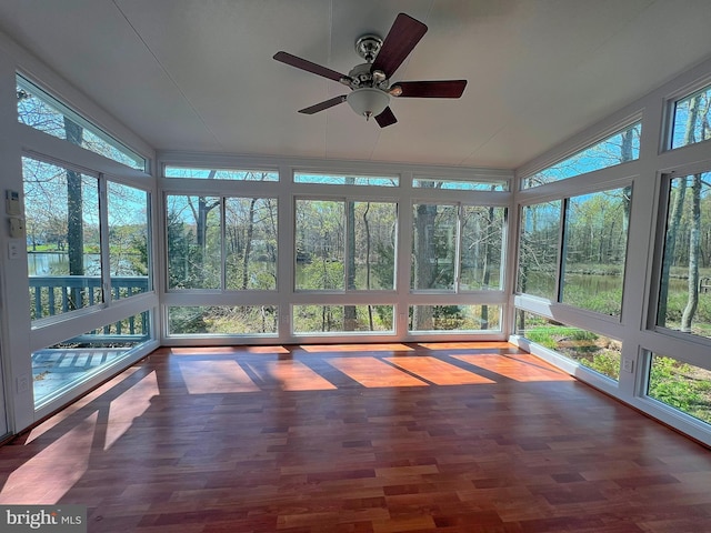 unfurnished sunroom with plenty of natural light, ceiling fan, and vaulted ceiling