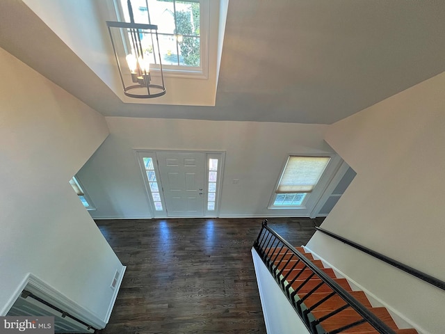 entryway featuring dark wood-style floors, stairway, plenty of natural light, and baseboards