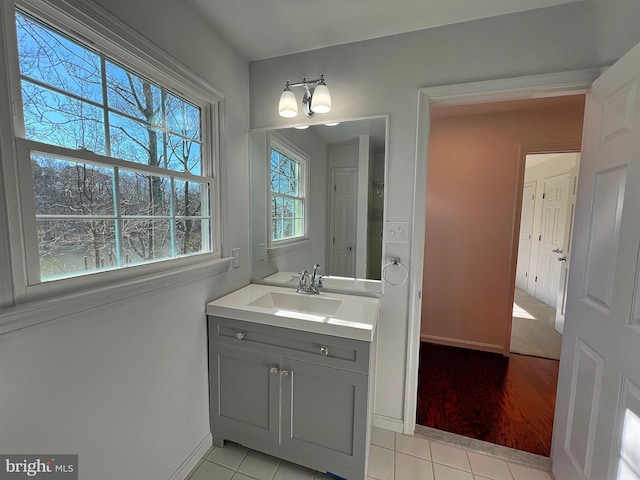 bathroom featuring baseboards, vanity, and tile patterned flooring