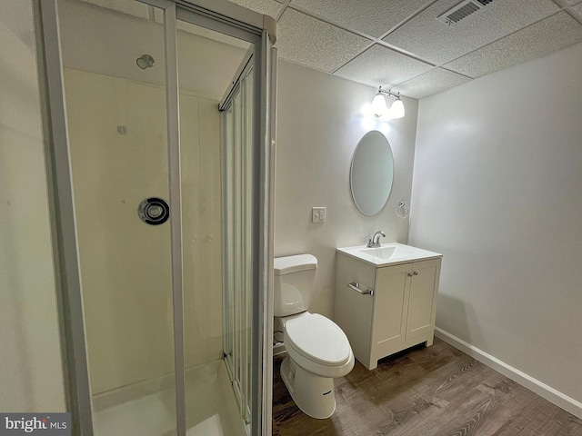 bathroom with visible vents, a shower stall, a paneled ceiling, and wood finished floors