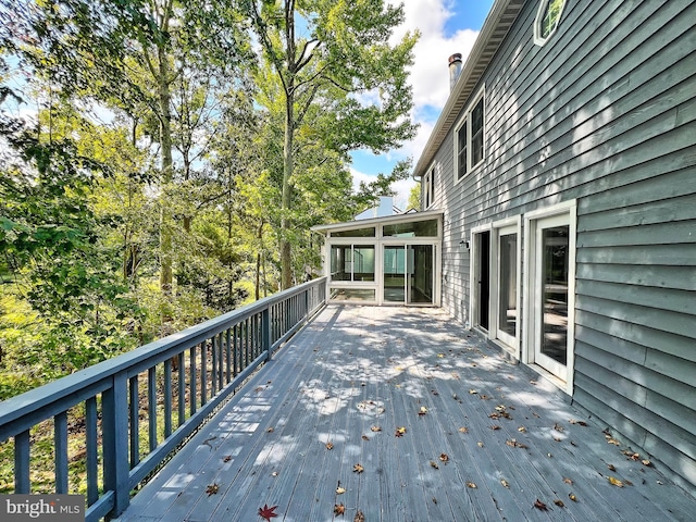 wooden deck with a sunroom