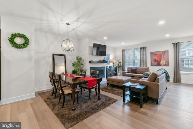 dining space with light wood finished floors, baseboards, and recessed lighting