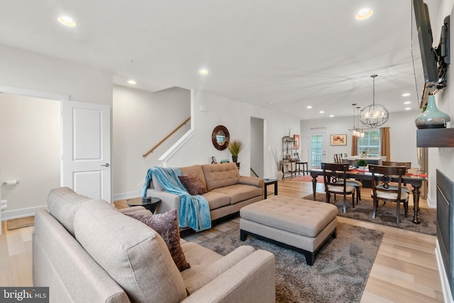 living room with baseboards, stairway, light wood-type flooring, and recessed lighting