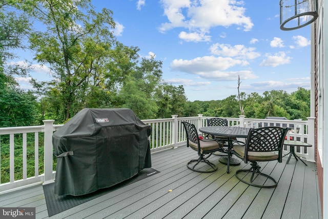 wooden deck featuring outdoor dining area and grilling area