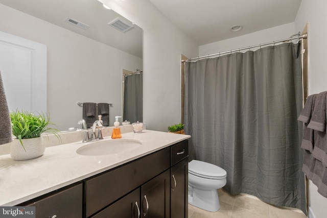 bathroom featuring toilet, tile patterned floors, visible vents, and vanity