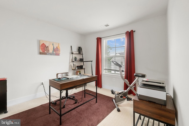 home office with carpet, visible vents, and baseboards