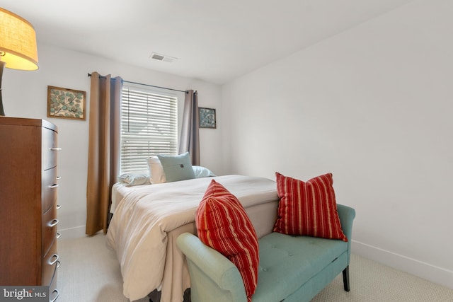 bedroom with light carpet, visible vents, and baseboards