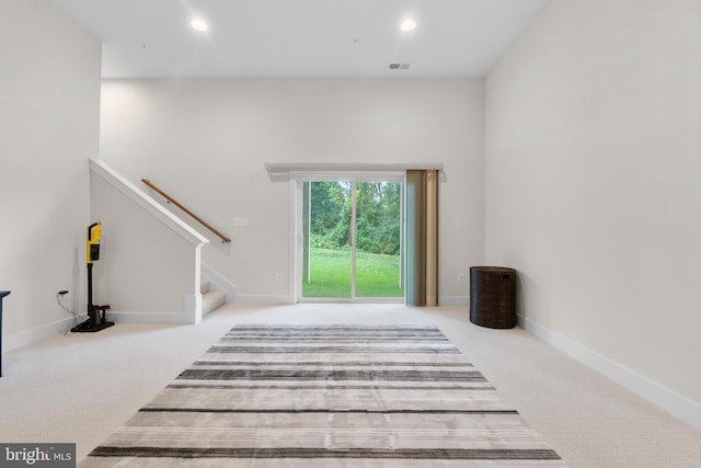 living room featuring carpet floors, visible vents, and recessed lighting