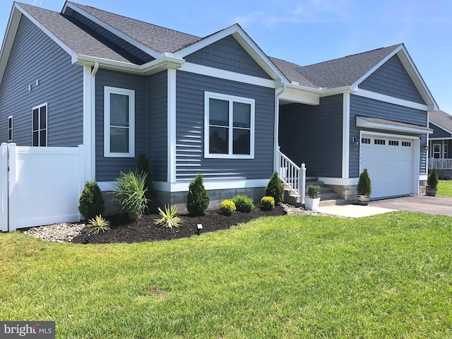 view of front of house featuring a garage and a front lawn