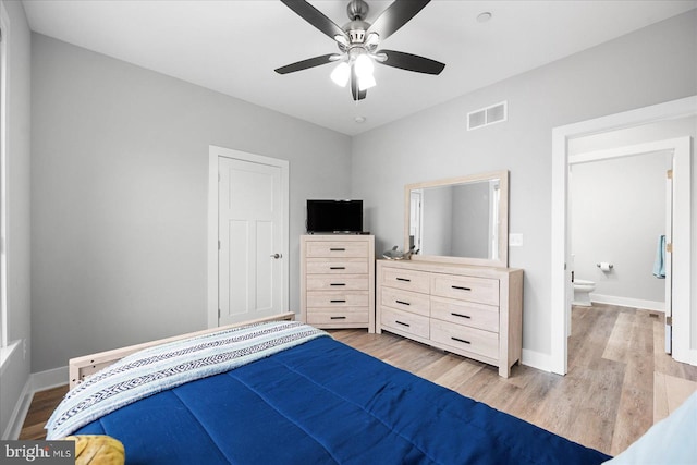 bedroom featuring visible vents, light wood-type flooring, and baseboards