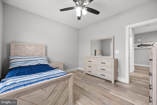 bedroom featuring baseboards, ceiling fan, and light wood finished floors