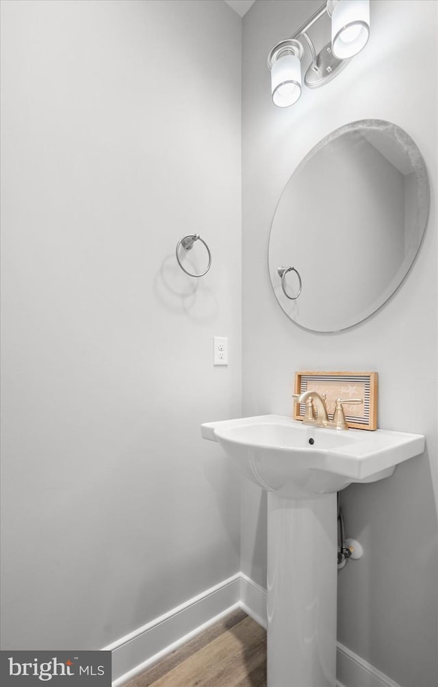 bathroom with baseboards and wood finished floors