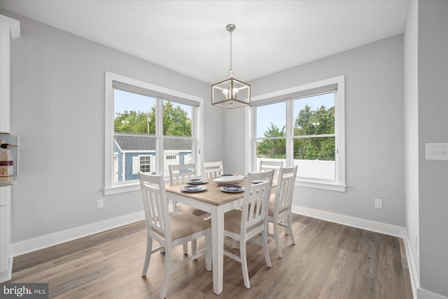 dining area featuring dark hardwood / wood-style floors and a chandelier