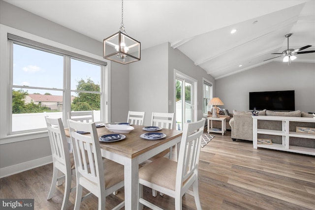 dining space featuring wood finished floors, baseboards, vaulted ceiling with beams, recessed lighting, and ceiling fan with notable chandelier