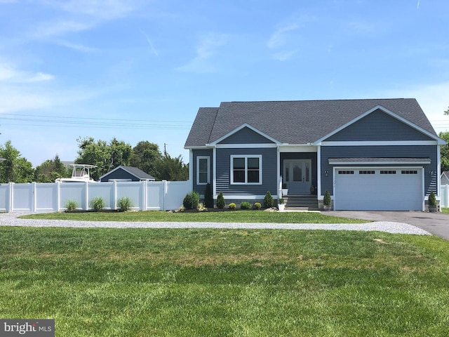 view of front of property with driveway, a front yard, and fence