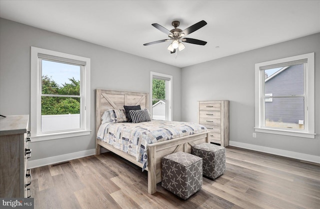 bedroom with hardwood / wood-style flooring and ceiling fan