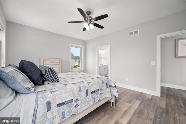 bedroom with ensuite bath, wood-type flooring, and ceiling fan