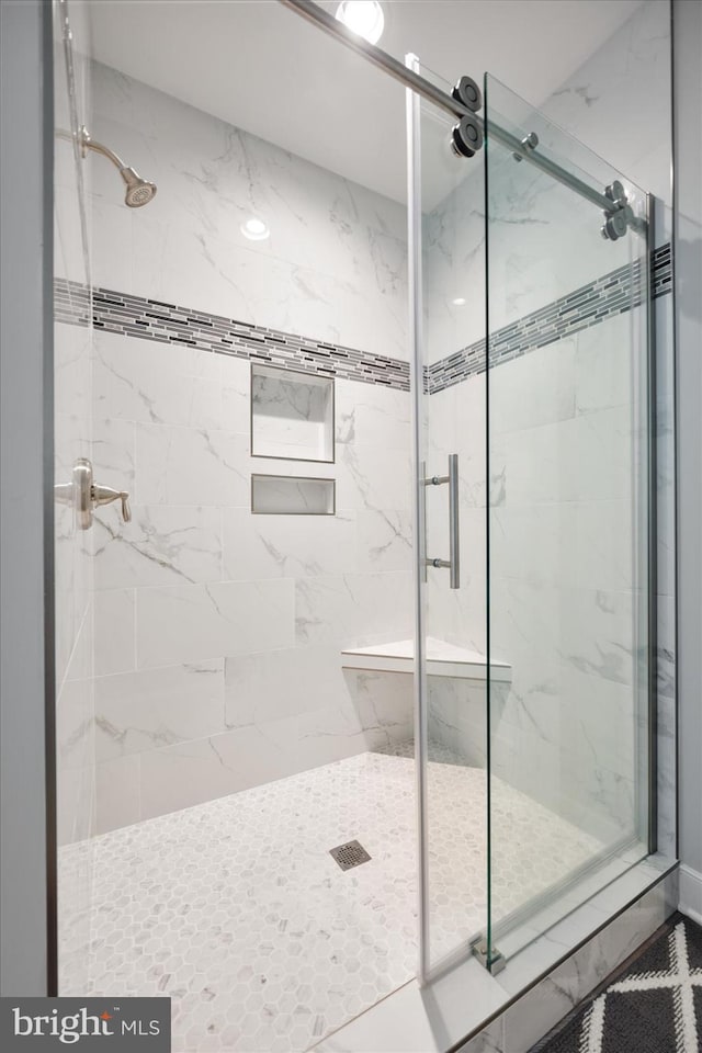 full bath featuring a marble finish shower