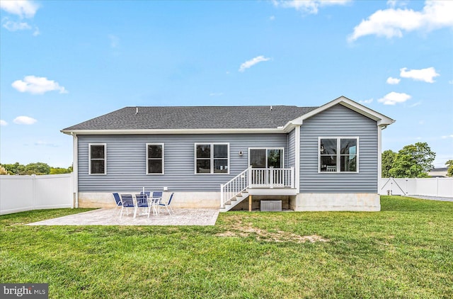 rear view of property with a patio, a lawn, a fenced backyard, and a shingled roof