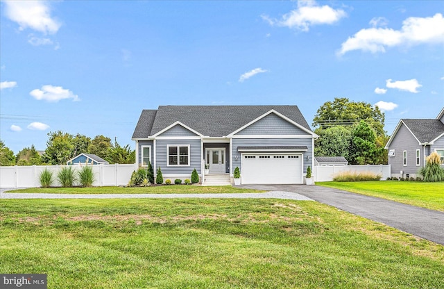 view of front facade with a front yard, fence, driveway, and a shingled roof