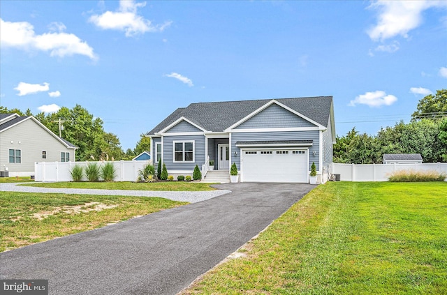 view of front of property featuring aphalt driveway, central AC unit, a front yard, and fence