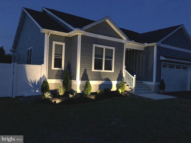 view of front of house featuring a garage and fence