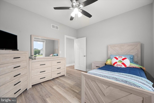 bedroom with light wood-type flooring, visible vents, baseboards, and a ceiling fan