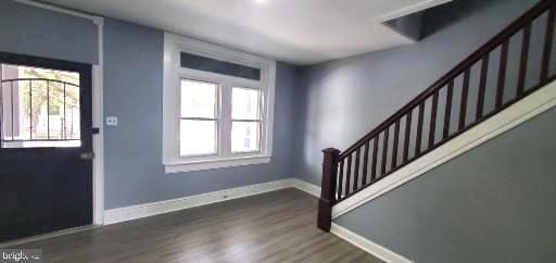 foyer entrance with a wealth of natural light and dark hardwood / wood-style floors