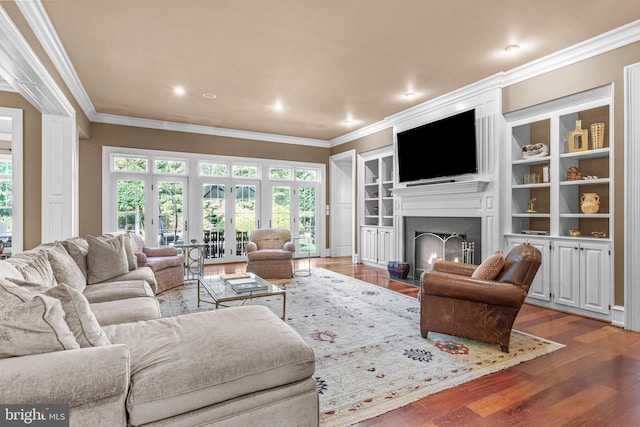 living room with crown molding, french doors, and wood-type flooring