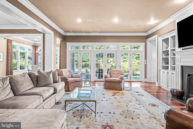 living room with hardwood / wood-style flooring, crown molding, and french doors