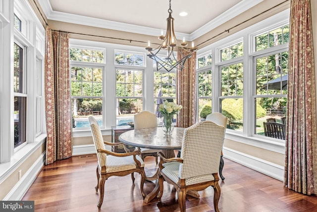 sunroom / solarium featuring an inviting chandelier and plenty of natural light