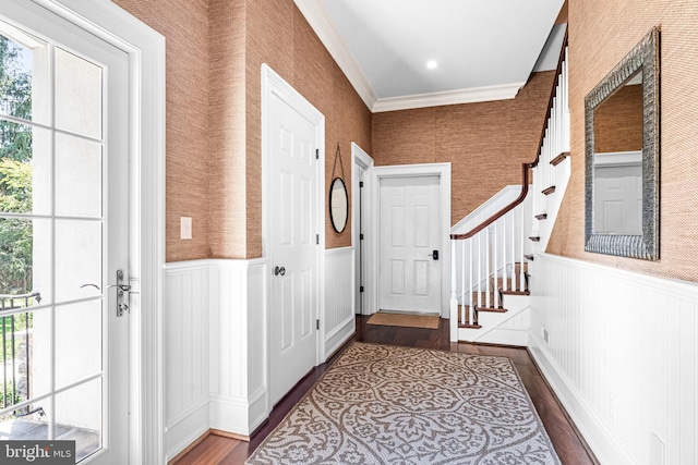 doorway with crown molding and hardwood / wood-style flooring