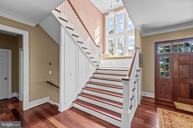 entryway with crown molding and dark hardwood / wood-style flooring