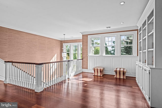 living area featuring crown molding and dark hardwood / wood-style flooring