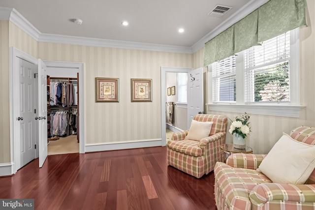 living area featuring dark wood-type flooring and crown molding