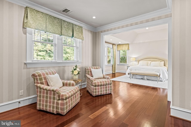 living area featuring crown molding and hardwood / wood-style floors