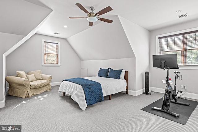 carpeted bedroom featuring ceiling fan, vaulted ceiling, and multiple windows