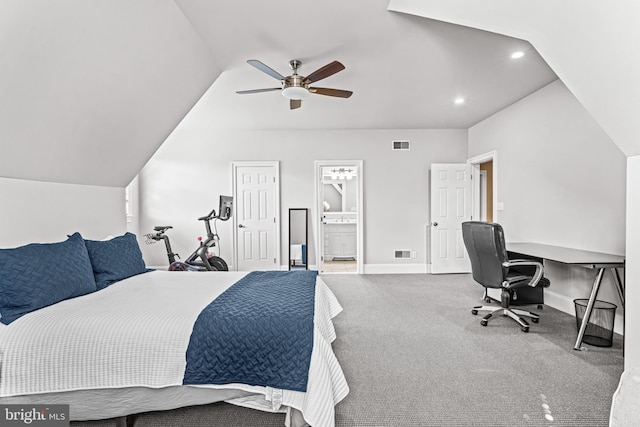 carpeted bedroom featuring ceiling fan, lofted ceiling, and ensuite bath